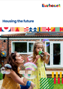 woman and child blow bubbles outside a house